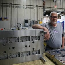 A 32-cavity mold for the consumer goods industry and one of our toolmakers